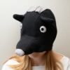 Handmade black bear costume hat made of fleece, featuring a unique white fringe on top and a white nose.