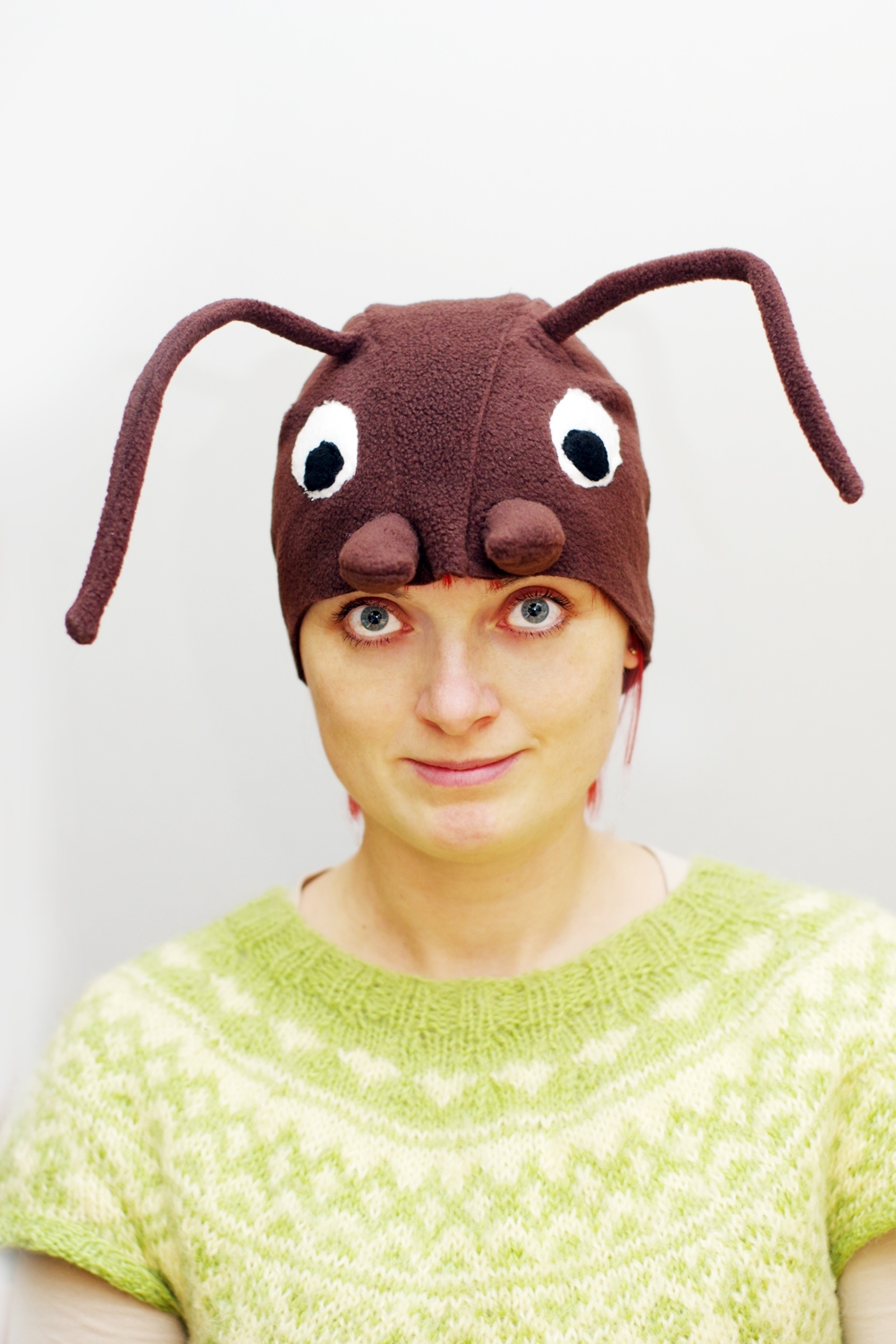 Handmade brown fleece wood ant costume hat for adults. The hat features large white eyes, brown mandibles, and long wired antennae.